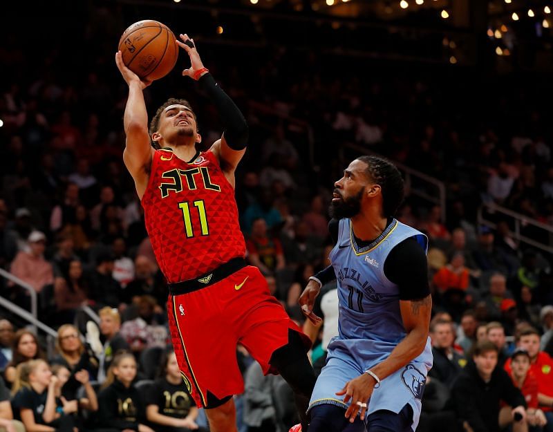Trae Young of the Atlanta Hawks draws a foul on Mike Conley