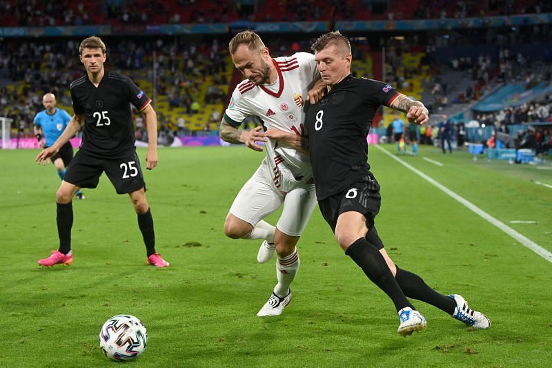 Germany&#039;s Toni Kroos tussles it out against Gergo Lovrencsics of Hungary