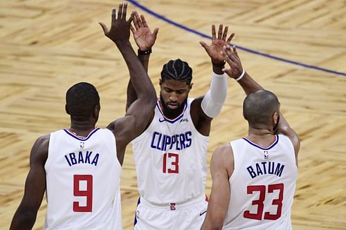 The LA Clippers' Paul George #13 celebrates with teammate Serge Ibaka #9