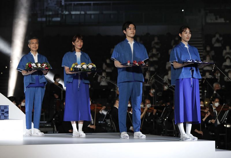 Models present items including podium, music, costume and medal tray to be used during the victory ceremonies at Tokyo Olympics and Paralympics