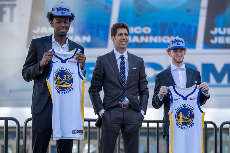 James Wiseman (left) and Nico Mannion (right) pose with the Golden State Warriors jersey