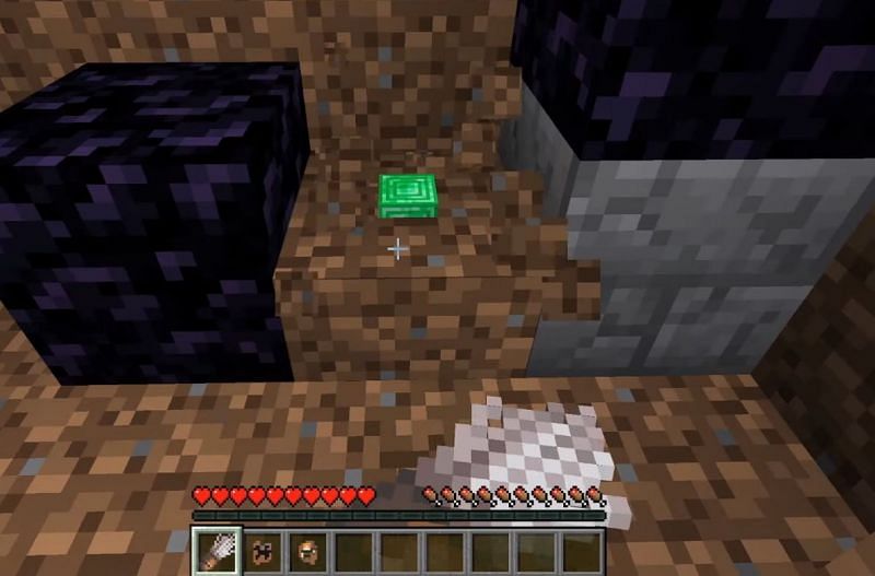 A player using a brush on a dirt block (Image via Minecraft on youtube)