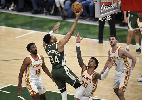 Giannis Antetokounmpo #34 shoots against John Collins #20.