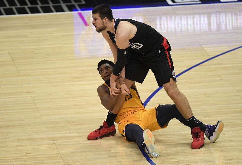 Donovan Mitchell #45 commits his fourth foul on Ivica Zubac #40.