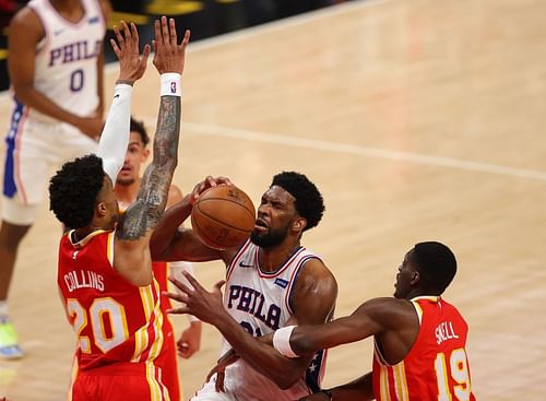 Joel Embiid #21 draws a foul from Tony Snell #19