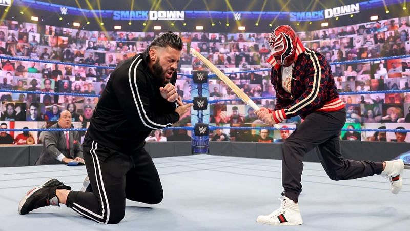 Rey Mysterio beating down Roman Reigns on SmackDown