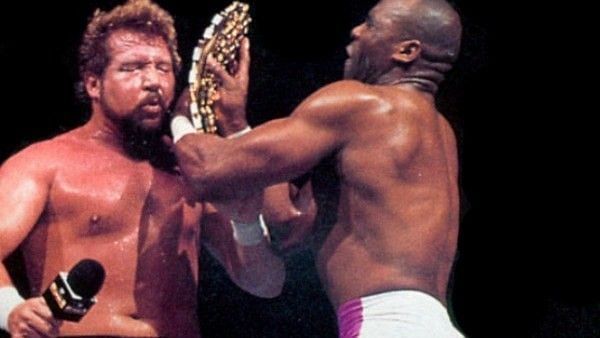Virgil using the title he would go on to win to attack Ted Dibiase Sr