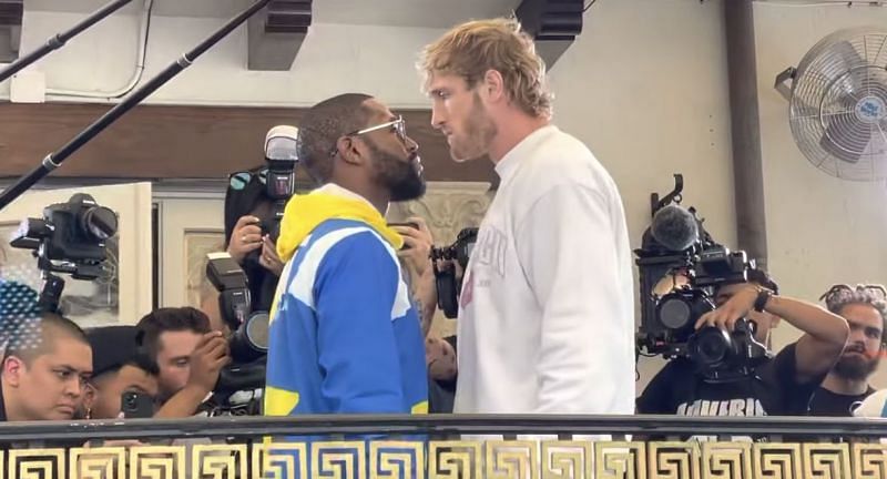 Logan Paul pokes fun at Floyd Mayweather for &quot;trying to kiss&quot; him during an intimidation stare at a press conference (Image via YouTube)
