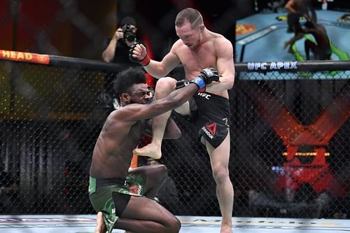 Petr Yan lands an illegal knee on Aljamain Sterling