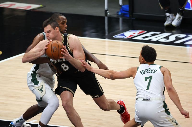 Danilo Gallinari #8 of the Hawks is fouled by Khris Middleton #22 of the Bucks