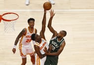 Forward Khris Middleton #22 of the Milwaukee Bucks shoots over center Clint Capela of the Atlanta Hawks