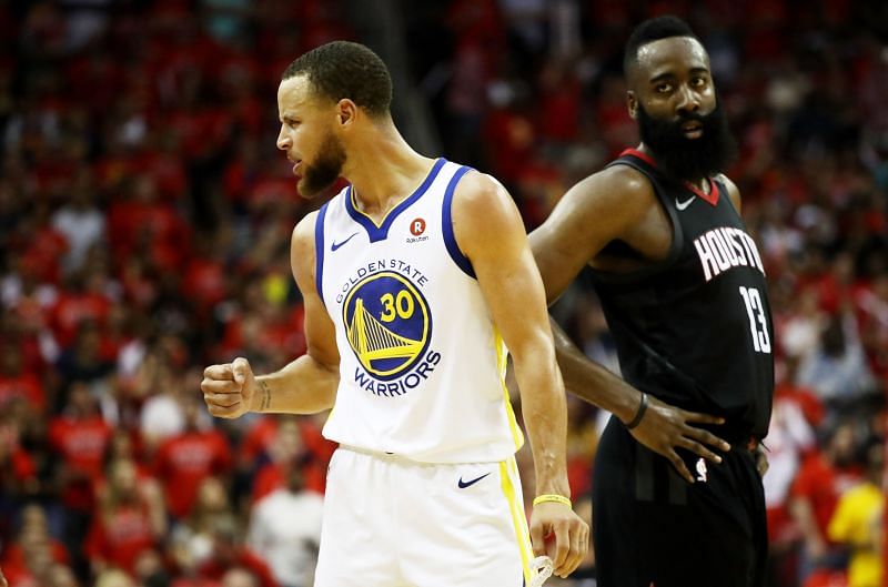 Stephen Curry (#30) of the Golden State Warriors reacts as James Harden (#13) of the Houston Rockets looks on in the third quarter of Game Seven of the Western Conference Finals in the 2018 NBA Playoffs.