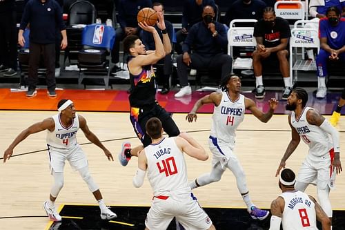 Devin Booker #1 puts up a shot over Rajon Rondo #4, Ivica Zubac #40, Terance Mann #14 and Paul George #13