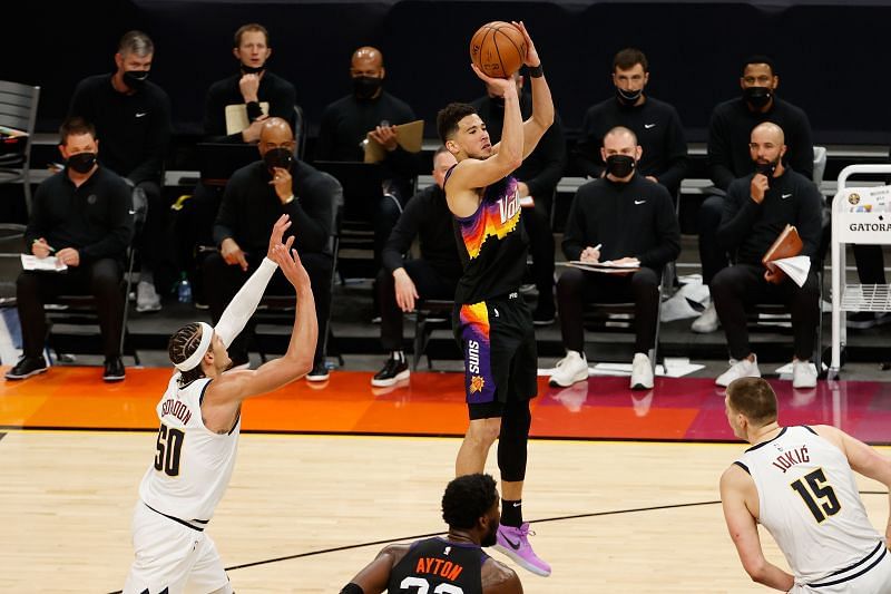 Devin Booker #1 shoots against the Nuggets