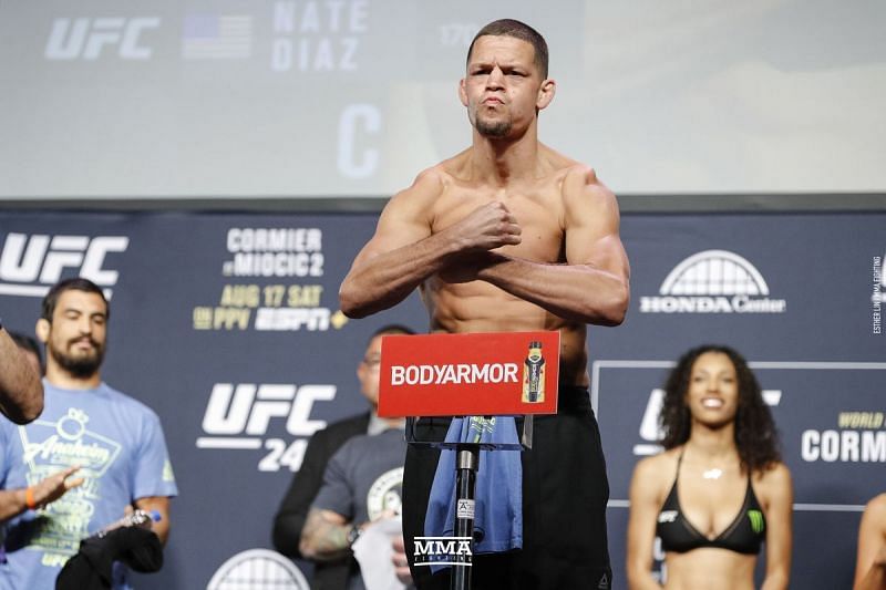 Nate Diaz flexes at a weigh-in