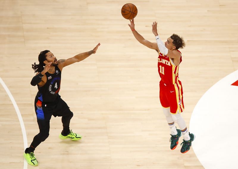 Trae Young #11 of the Atlanta Hawks shoots over Derrick Rose #4