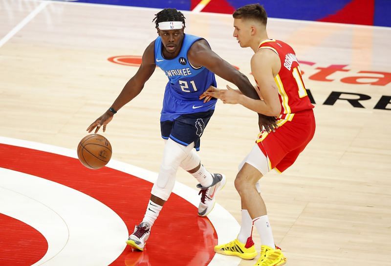 Jrue Holiday (#21) of the Milwaukee Bucks moves the ball against Bogdan Bogdanovic (#13) of the Atlanta Hawks