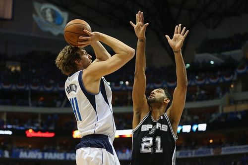 Dirk Nowitzki #41 of the Dallas Mavericks takes a shot against Tim Duncan.