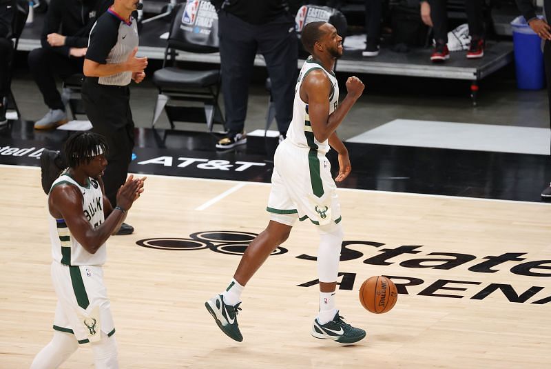 Khris Middleton (#22) and Jrue Holiday (#21) celebrate a series win.