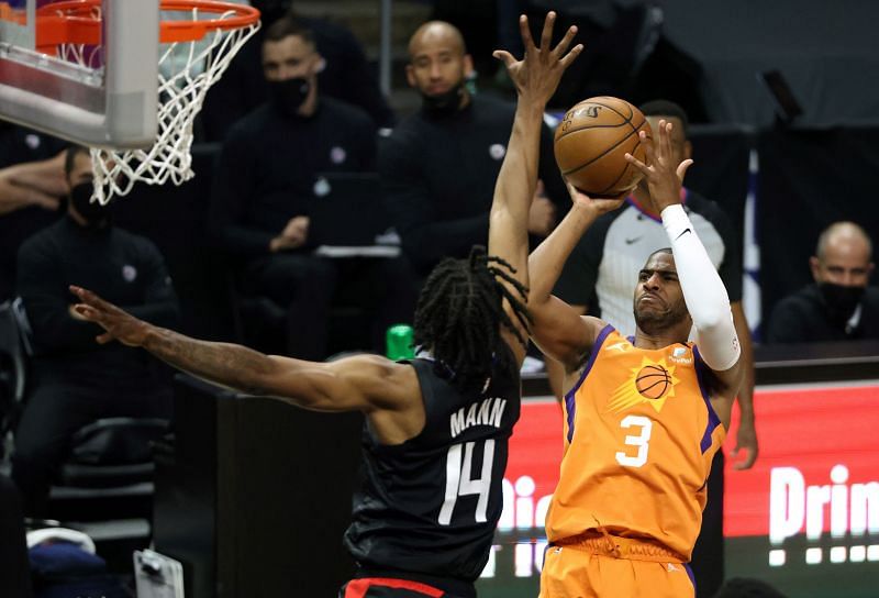 Chris Paul #3 of the Phoenix Suns goes up for a shot against Terance Mann #14 of the LA Clippers during the first half in Game Six of the Western Conference Finals