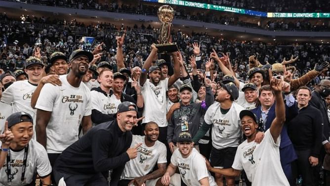 Triple H congratulates Giannis Antetokounmpo and the Milwaukee Bucks with a customized championship belt