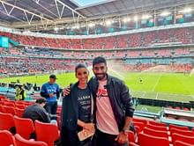 Sanjana Ganesan and Jasprit Bumrah pose during Italy vs Spain clash at Wembley