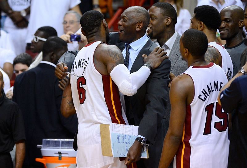 Assistant coach Bob McAdoo of the Miami Heat celebrates with LeBron James.