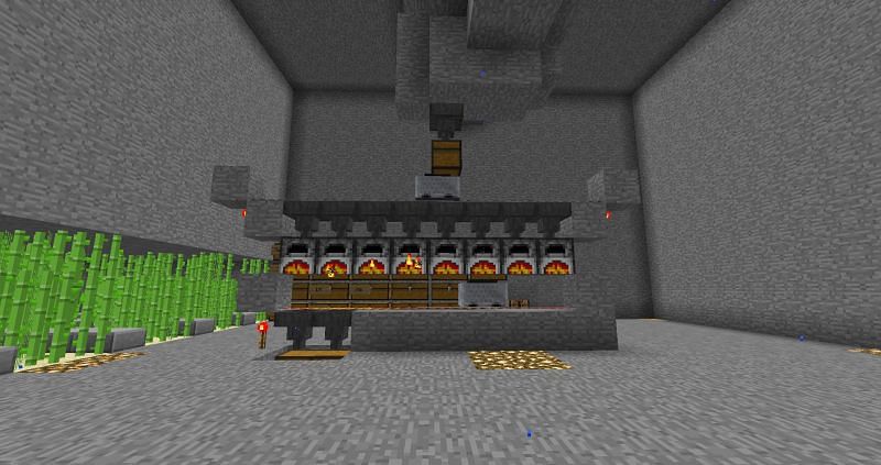 Using a minecart with hopper to create an automatic smeltery system (Image via u/Gocountgrainsofsand on Reddit)