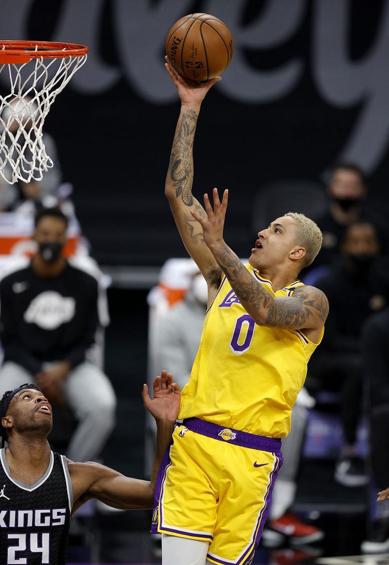 Kyle Kuzma #0 of the Los Angeles Lakers goes up for a shot on Buddy Hield #24 of the Sacramento Kings