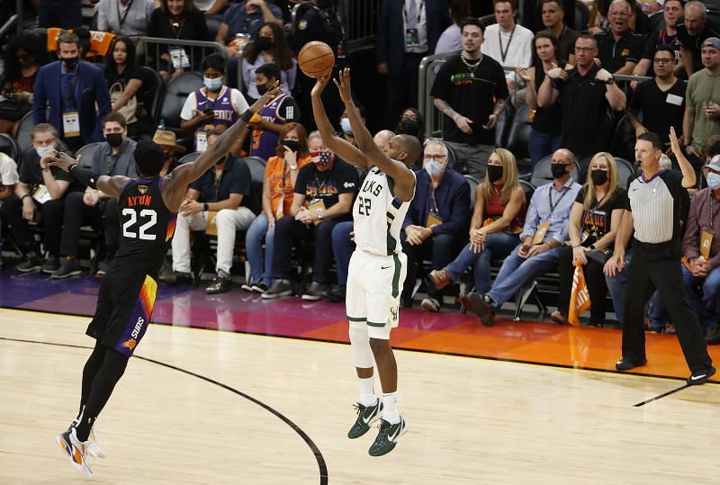 The Milwaukee Bucks&#039; Khris Middleton #22 shoots against the Phoenix Suns&#039; Deandre Ayton #22 during the second half