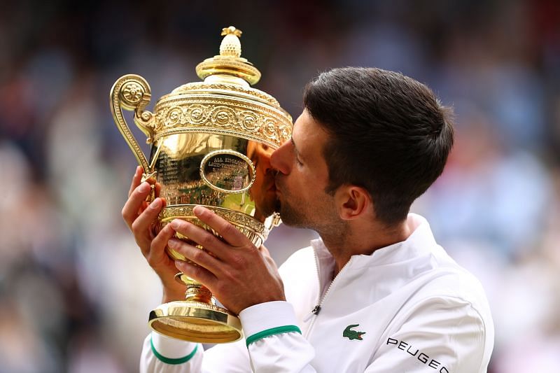 Novak Djokovic poses with his sixth Wimbledon title.