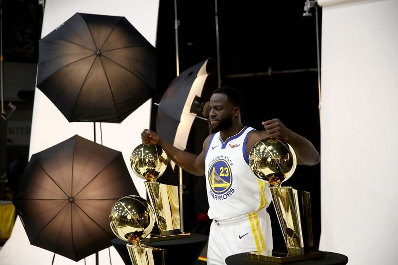 Draymond Green #23 of the Golden State Warriors poses with three Larry O&#039;Brien NBA Championship Trophies