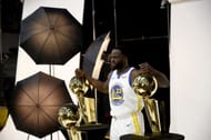 Draymond Green #23 of the Golden State Warriors poses with three Larry O'Brien NBA Championship Trophies