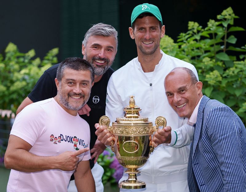 Novak Djokovic and his coaching team pose with the Wimbledon title