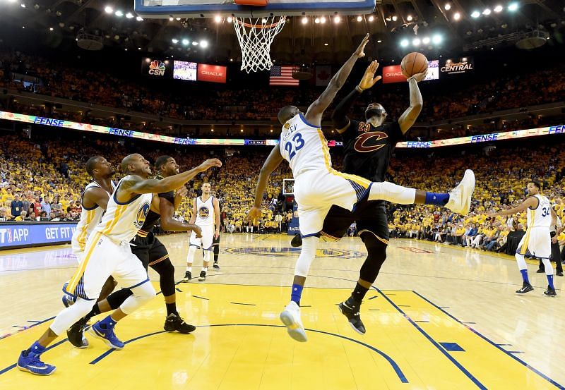 LeBron James #23 of the Cleveland Cavaliers takes a shot against Draymond Green #23 of the Golden State Warriors in Game 7 of the 2016 NBA Finals