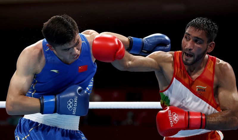 Ashish Kumar (R) of India exchanges punches with Erbieke Tuoheta of China during the Men&#039;s Middle (69-75kg) on day three of the Tokyo 2020 Olympic Games