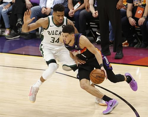 Devin Booker drives on Giannis Antetokounmpo