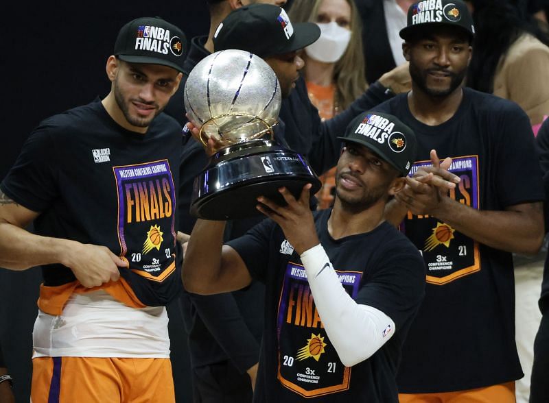 Chris Paul #3 of the Phoenix Suns holds the Western Conference Championship trophy