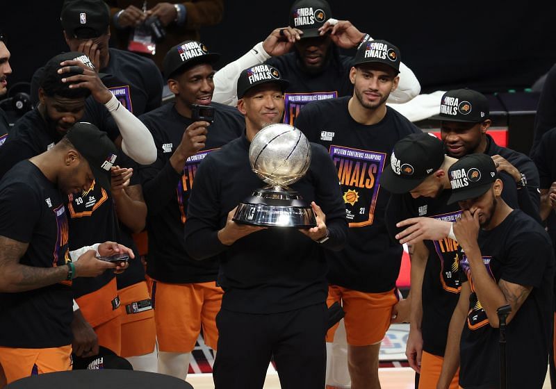 Phoenix Suns coach Monty Williams holds up the Western Conference Finals trophy