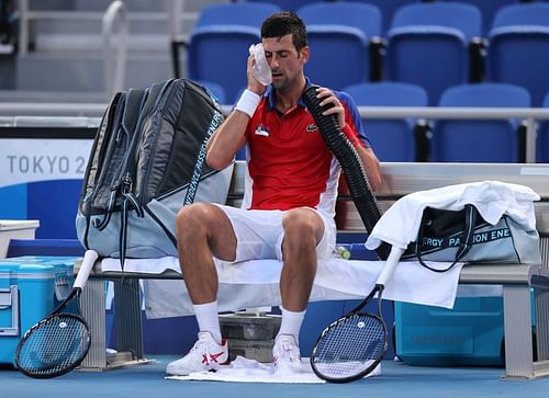 Novak Djokovic tries to cool himself during play