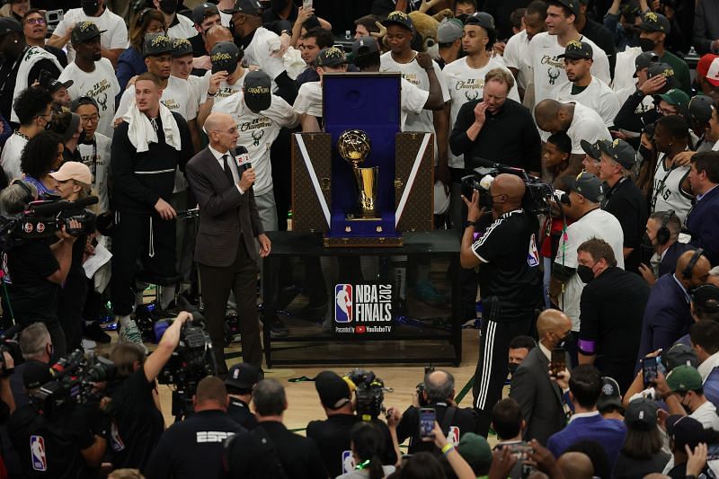 NBA commissioner Adam Silver presents the NBA title trophy to the Milwaukee Bucks after they beat the Phoenix Suns in Game Six of the NBA Finals.