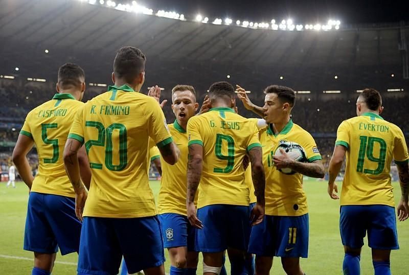 Brazil players celebrate one of their two goals against Argentina