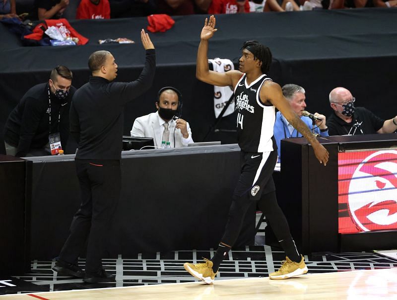 Terance Mann (#14) of the LA Clippers is congratulated by head coach Tyronn Lue.