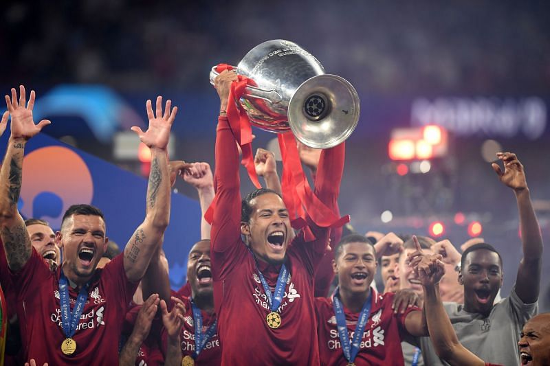 Virgil van Dijk (centre) holds aloft the 2019 UEFA Champions League trophy