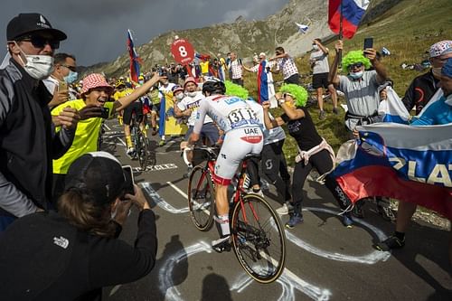 Tadej Pogacar of Slovenia crosses as fans cheer