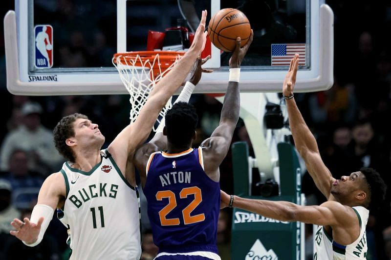 Brook Lopez and Giannis Antetokounmpo in action against Deandre Ayton [Source: The Athletic]