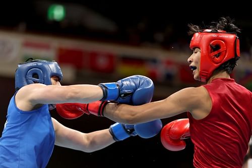 India's Lovlina Borgohain (red) exchanges punches with Chen Nien-chin of Chinese Taipei during their welterweight quarterfinal bout on Friday