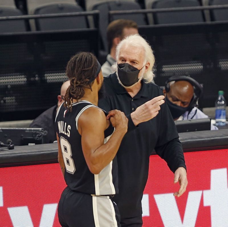 Gregg Popovich head coach gives advice to Patty Mills #8.