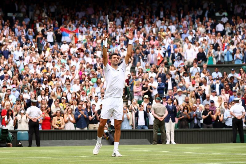 Novak Djokovic acknowledges the crowd after winning the Wimbledon 2021 title.