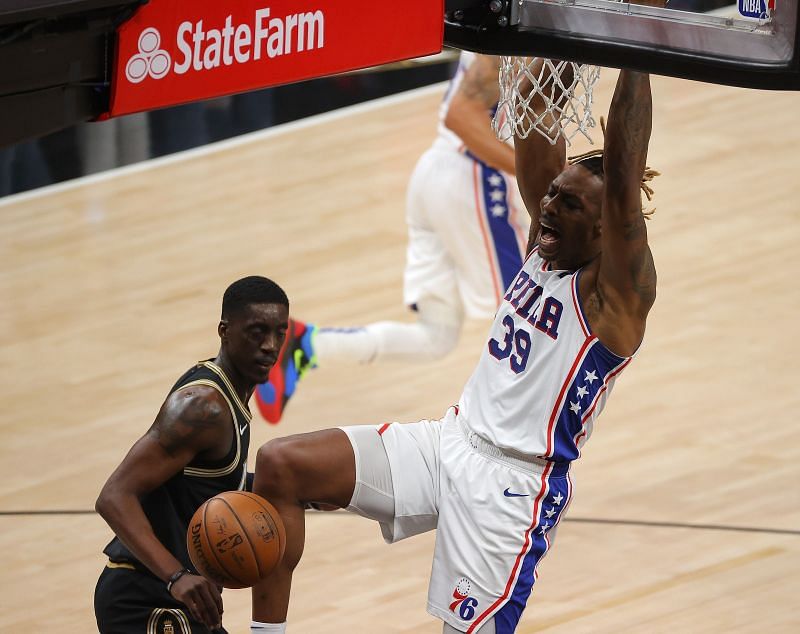 Dwight Howard #39 reacts after a dunk against Tony Snell #19.